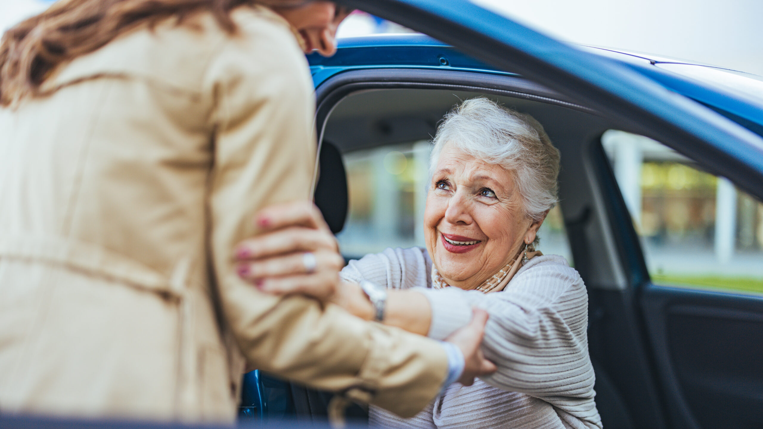 Handicap accessible transportation driver assisting elderly patient from vehicle